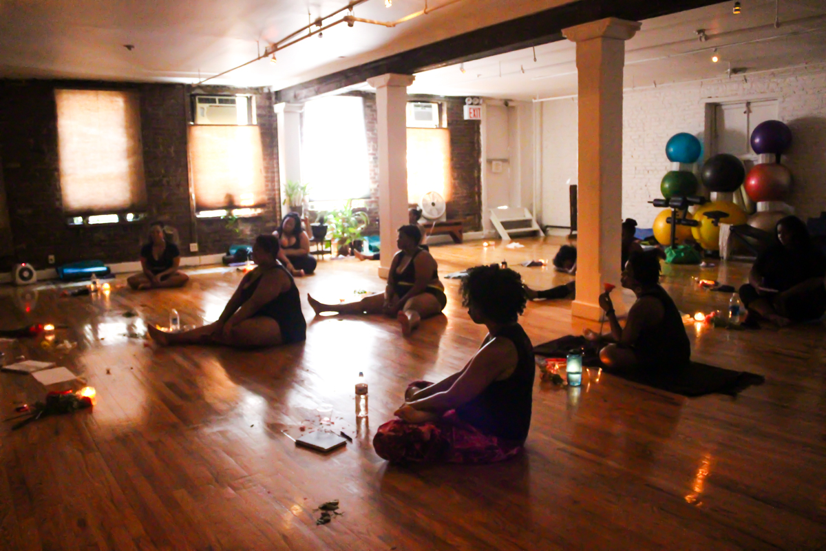 Participants seated in a candlelit circle
